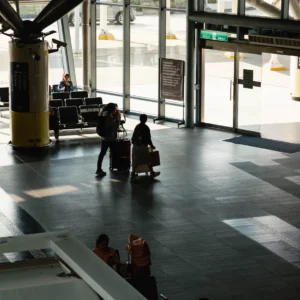 Travellers with luggage in a modern airport terminal